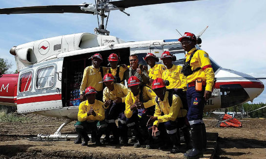 A group of South African firefighters poses in front of a Coldstream Helicopters machine. Coldstream Helicopters Photo