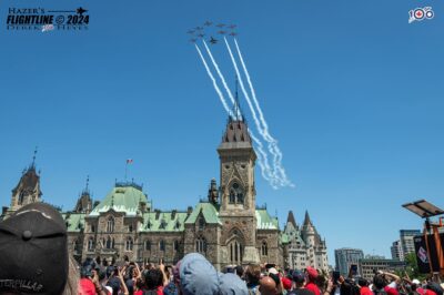 The CF Snowbirds and CF-18 Demo jet perform a flypast over Parliament Hill in Ottawa on Canada Day 2024. Derek Heyes Photo